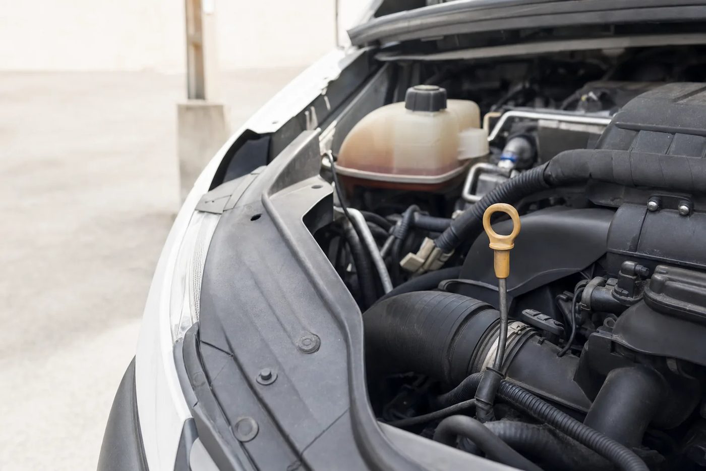 Compartiment moteur ouvert d'un utilitaire, jauge d'huile au premier plan